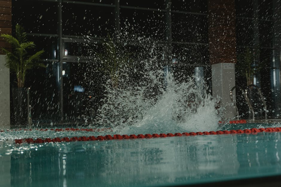 Dramatic splash in dark indoor pool